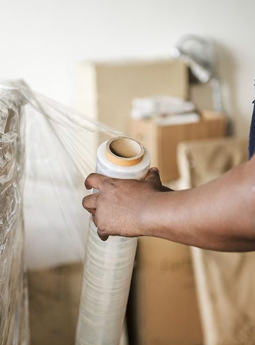 Black man moving furniture